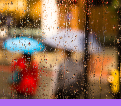 Rain falling on a window with people holding umbrellas blurred through the window. Rain falling on a window with people holding umbrellas blurred through the window.